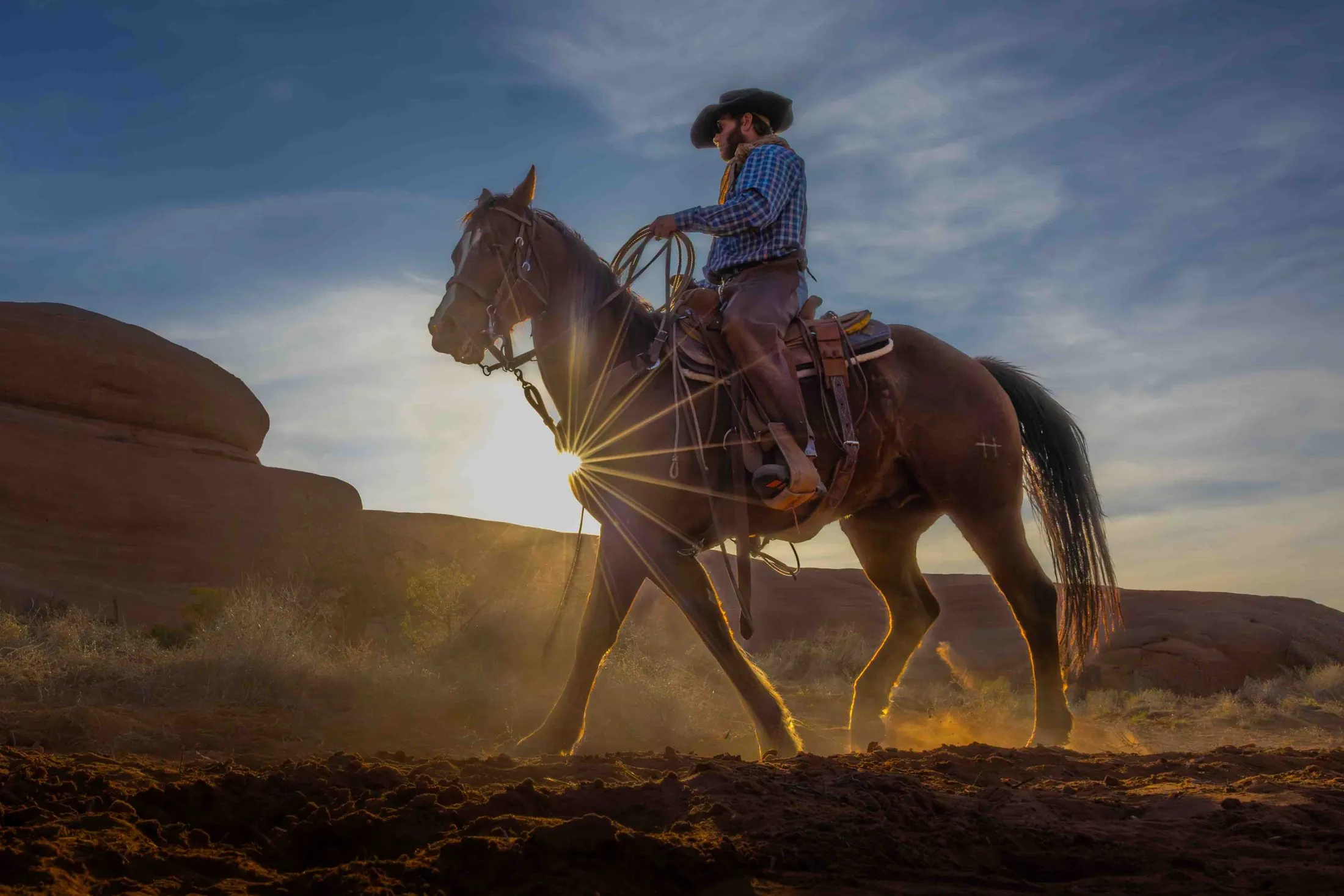 Bill Farr — cowboy on horseback at sunrise in the red-rock country near Moab, Utah